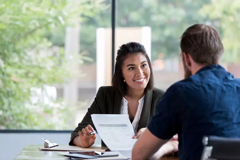 Man discussing with personal loan consultant in order to help with financing home improvements.