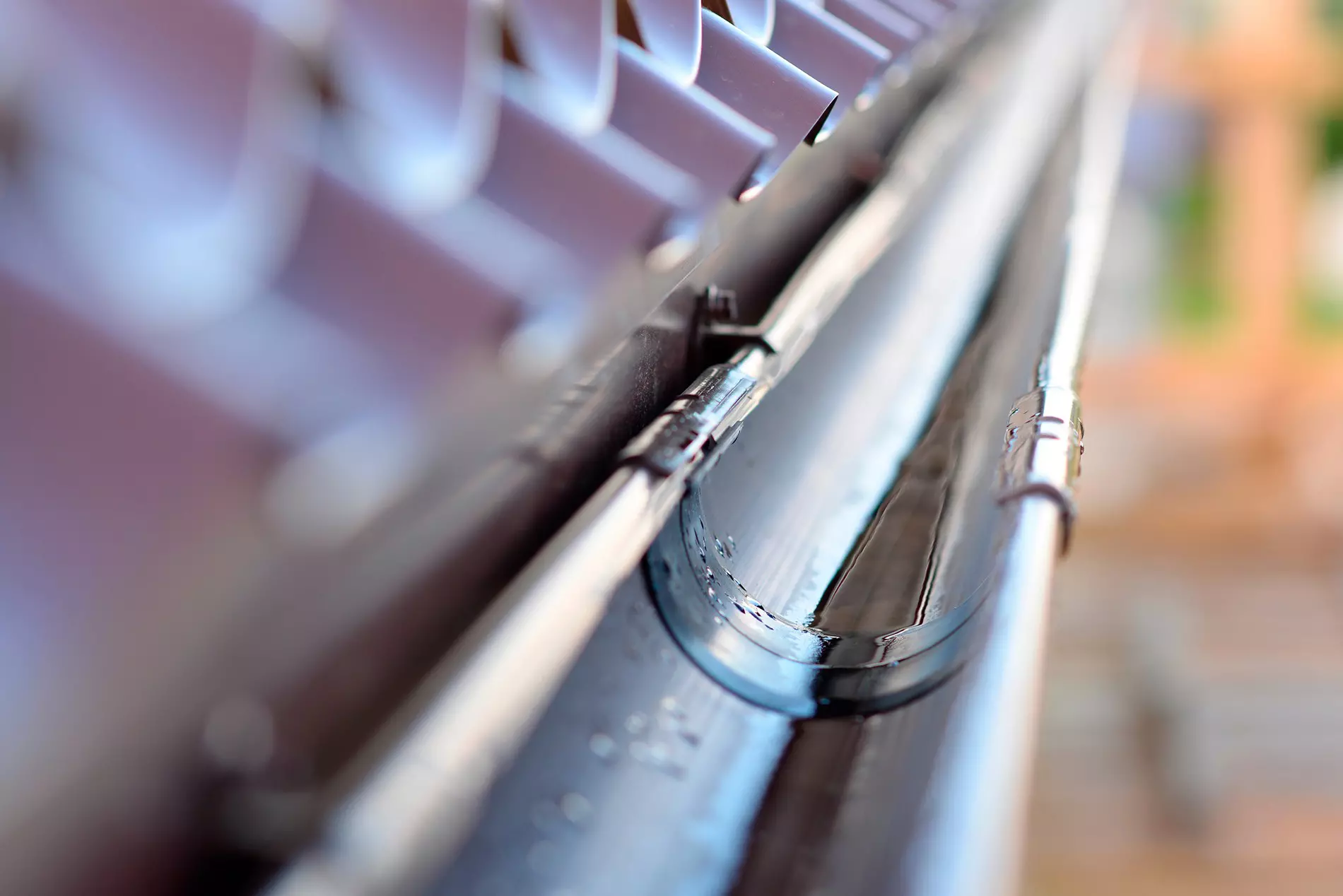A close-up view of a half-round rain gutter