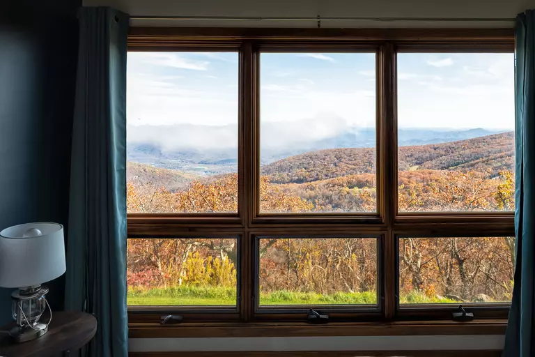 A window with a view of a mountain landscape.