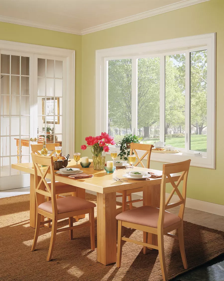 A wooden table with bay and bow windows 