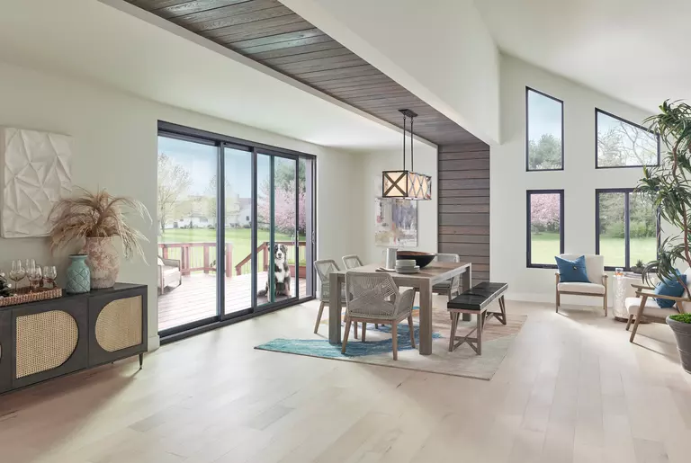 Geometric windows in an open dining room, allowing the space to feel brighter.