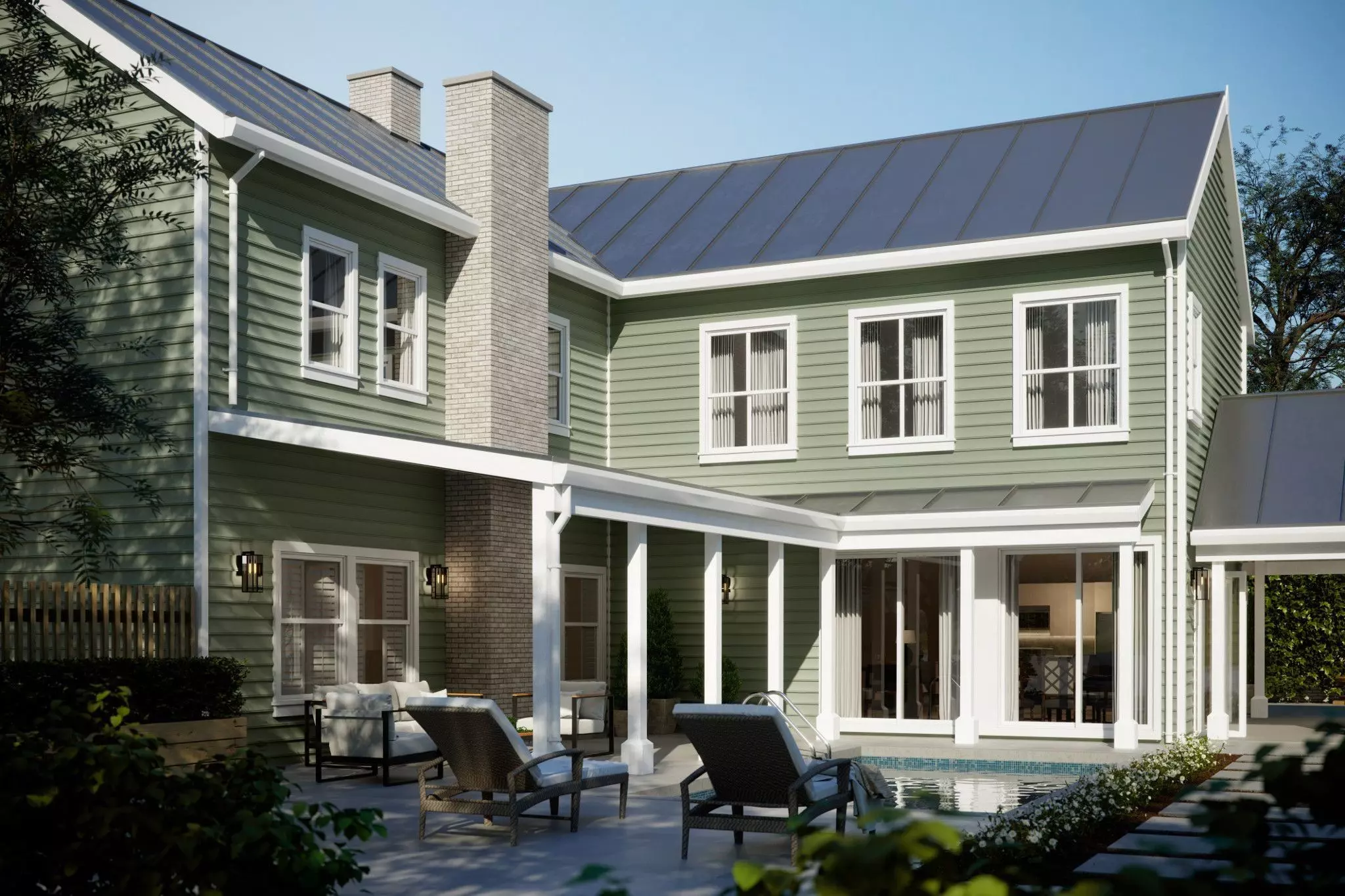 Green-colored mastic vinyl siding on a home with pool and pool chairs of back patio area shown.