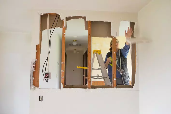 A woman remodels her ranch home by removing walls