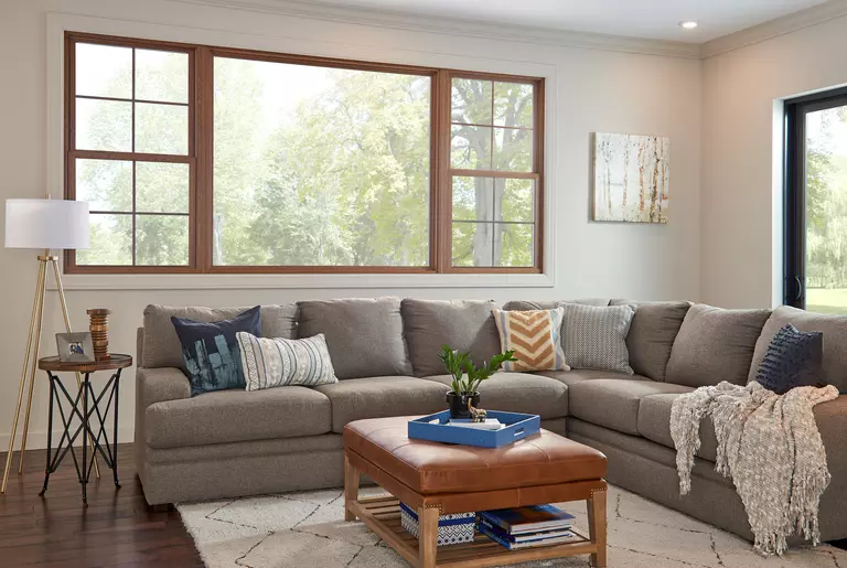 A picture window in a living room with two double-hung windows of matching style.