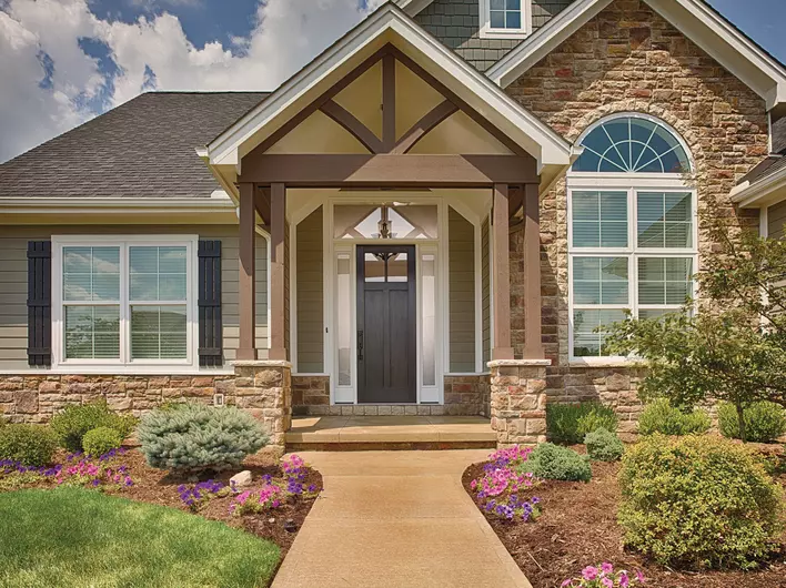 The exterior of a siding and stone home with large, insulated, energy-efficient windows
throughout.