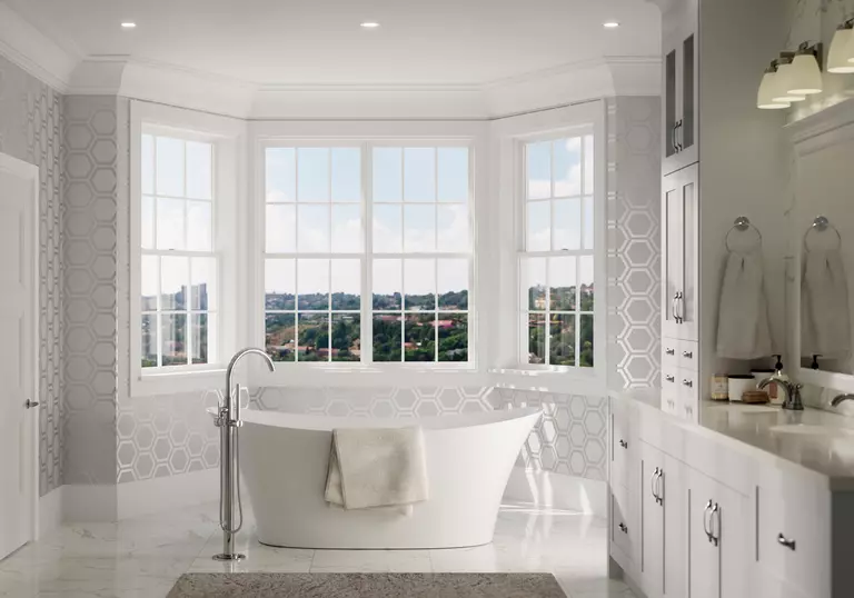 Bathroom with four white double-hung windows with grids.