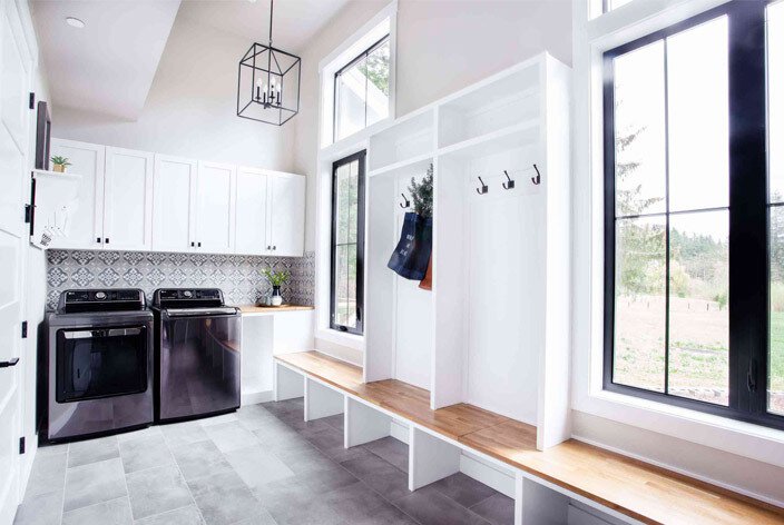 Mudroom with casement windows and a washing machine and dryer