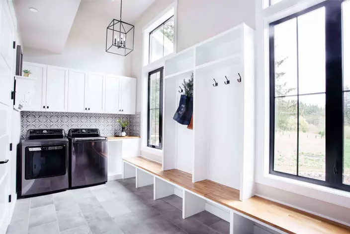 Mudroom with casement windows and a washing machine and dryer