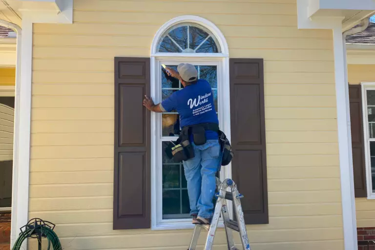 A certified Window World specialist installing a double-hung window.