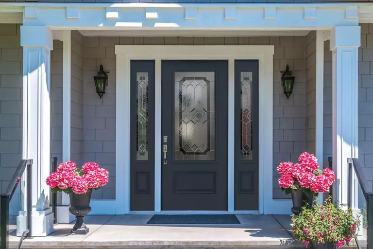 A dark front door and sidelites with Majestic decorative glass.