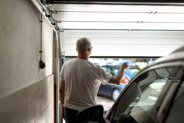 Homeowner opening a garage from inside.