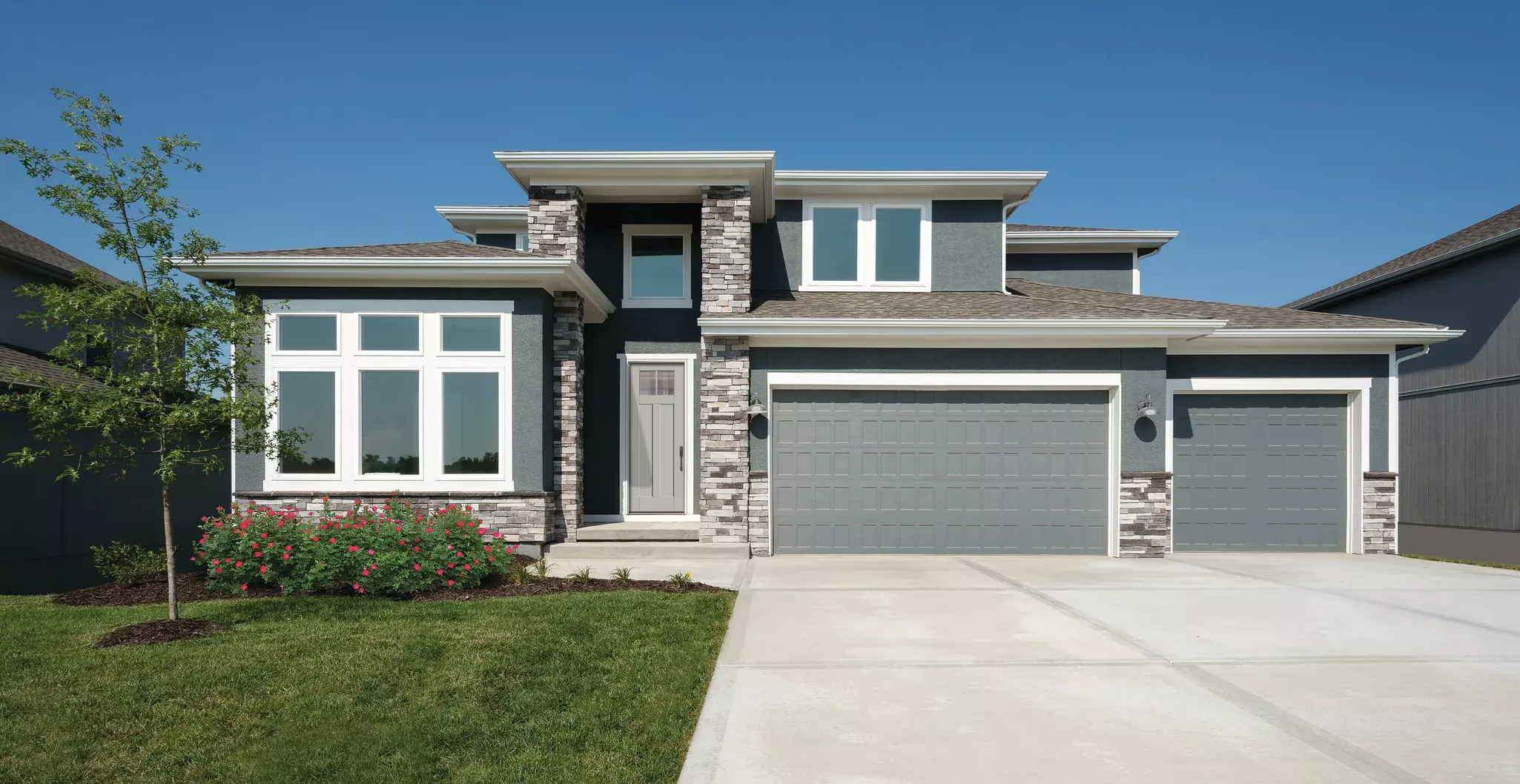 Modern two-story residential home with white windows.