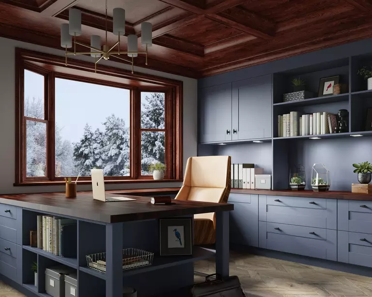 An office with a window and snow outside.
