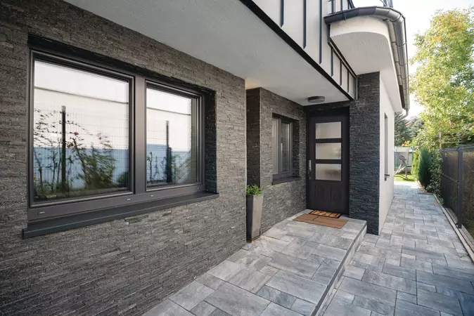 Textured Steel Entry Door, in a 3/4 Lite, 2 Panels door style and Modern Wide Simulated Divided Lites with Rain glass, prefinished in Obsidian, and with a Baldwin Del Mar Handleset in Satin Nickel.