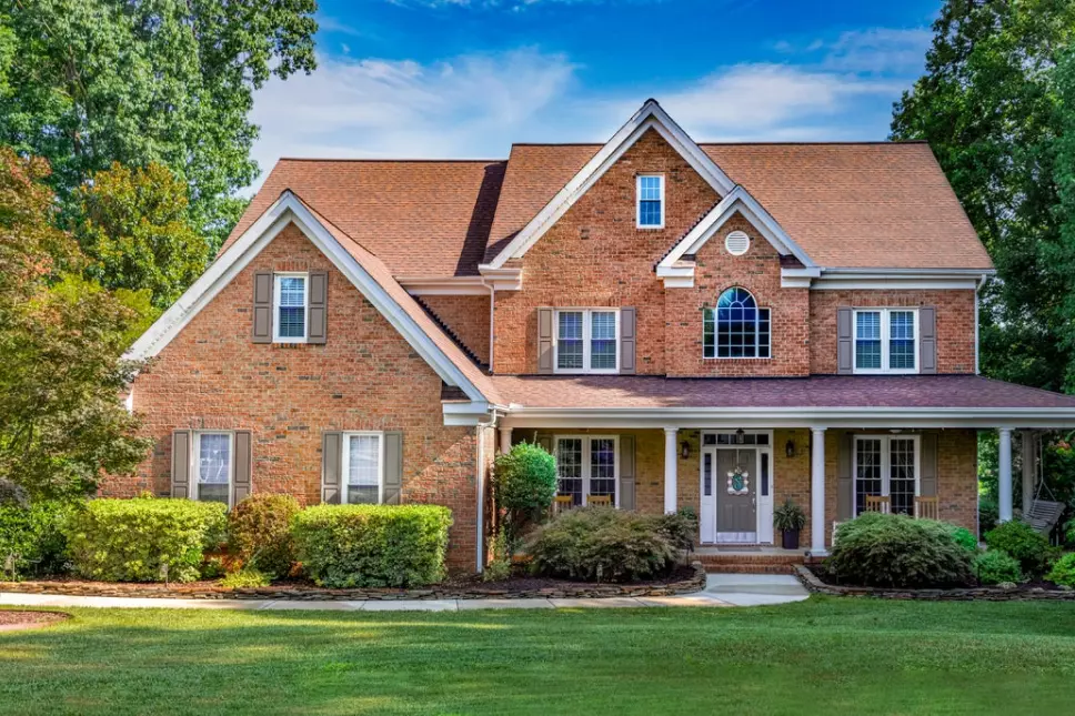 Exterior of a two-story light brown brick home