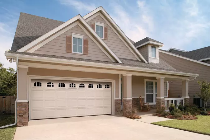White colonial panel garage doors with cascade windows