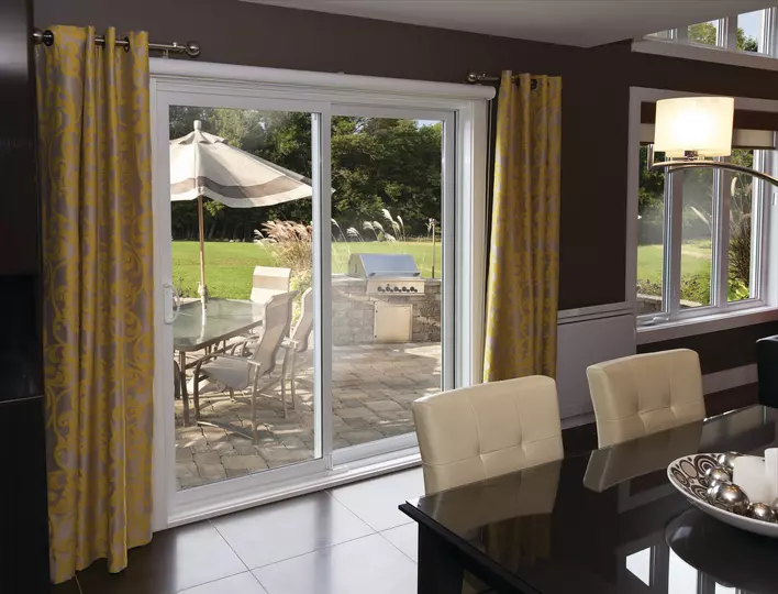An elegant dining room with a sliding patio door looking into the backyard.