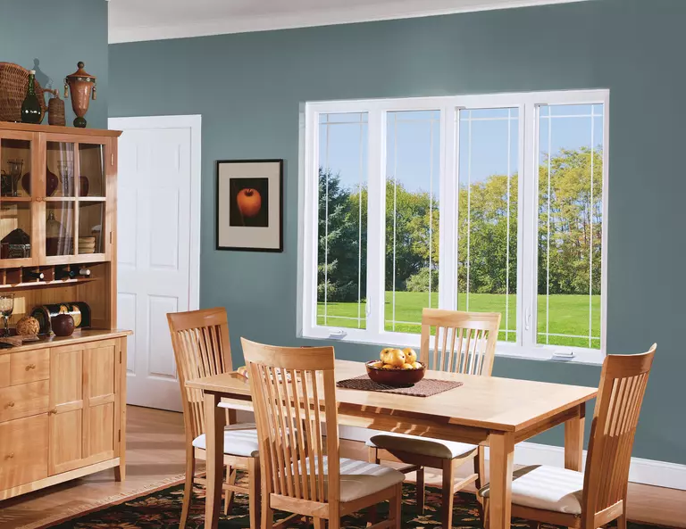 Dining room of a home with four white casement windows.