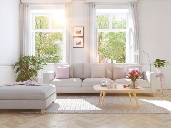 Living room with large open casement windows and white curtains
