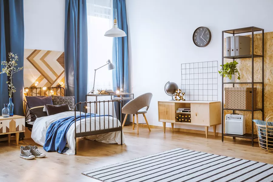modern teenage boy bedroom with large windows and wood floors