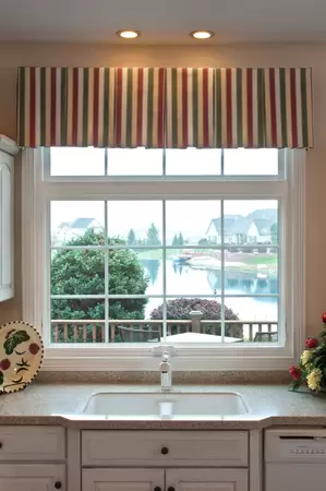 Restorations series white awning window in front of a kitchen sink