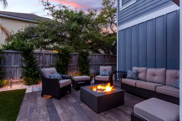 Patio furniture gathered around a fire pit