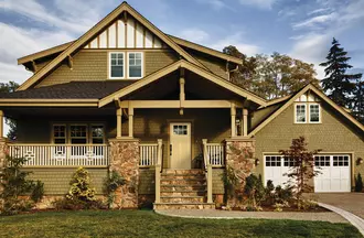 Craftsman-style home with a smooth fiberglass entry door, with a Craftsman Lite, 2-Panel Flat Shaker door style and Simulated Divided Lite glass, prefinished in French Manor.