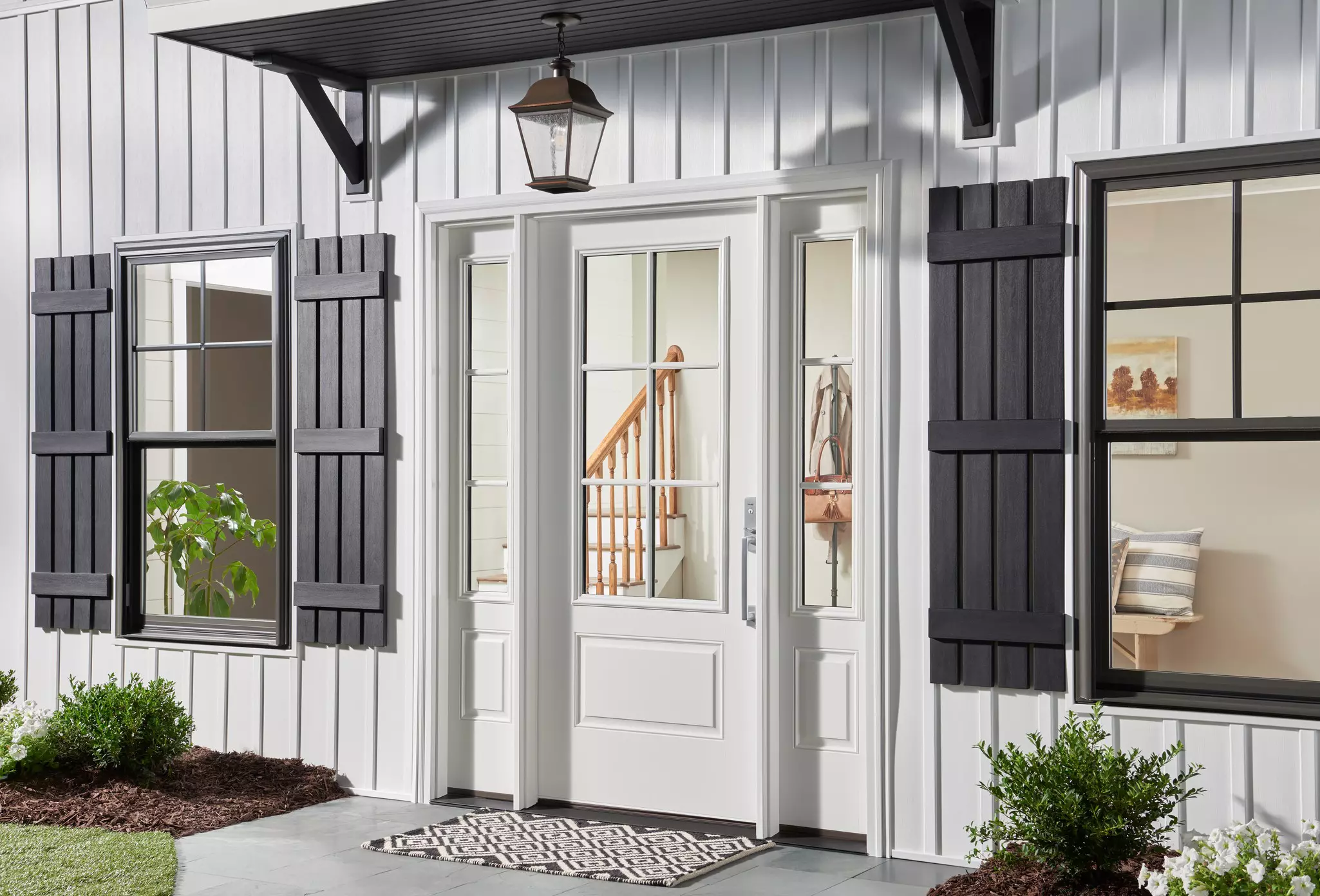 Front door of a home with vertical white siding.