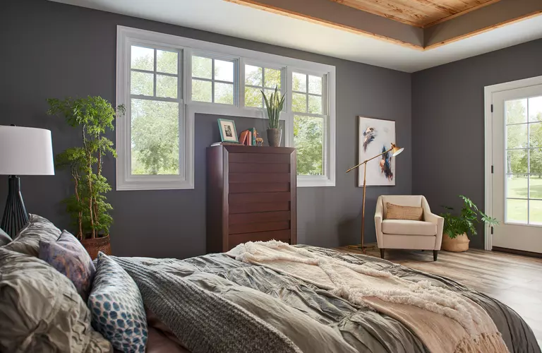 Combination of mulled double-hung and picture windows inside a bedroom.