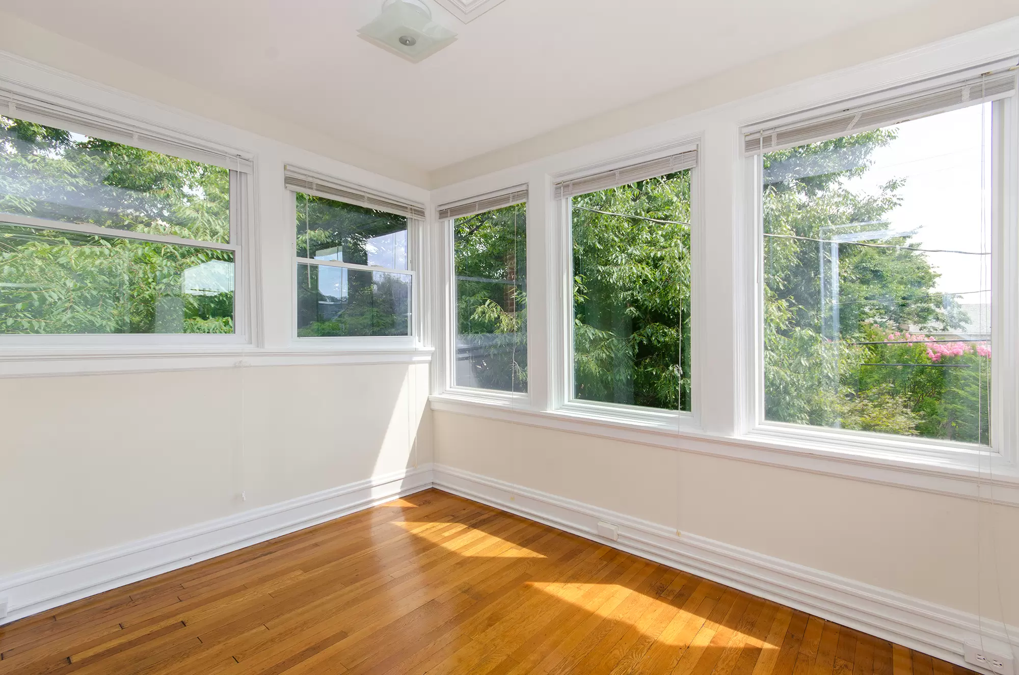 Corner of room with large windows on both walls.