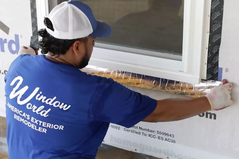 Window World employee replacing windows on a home.