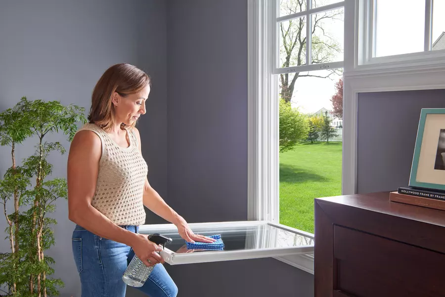 A woman cleaning a noise reducing window