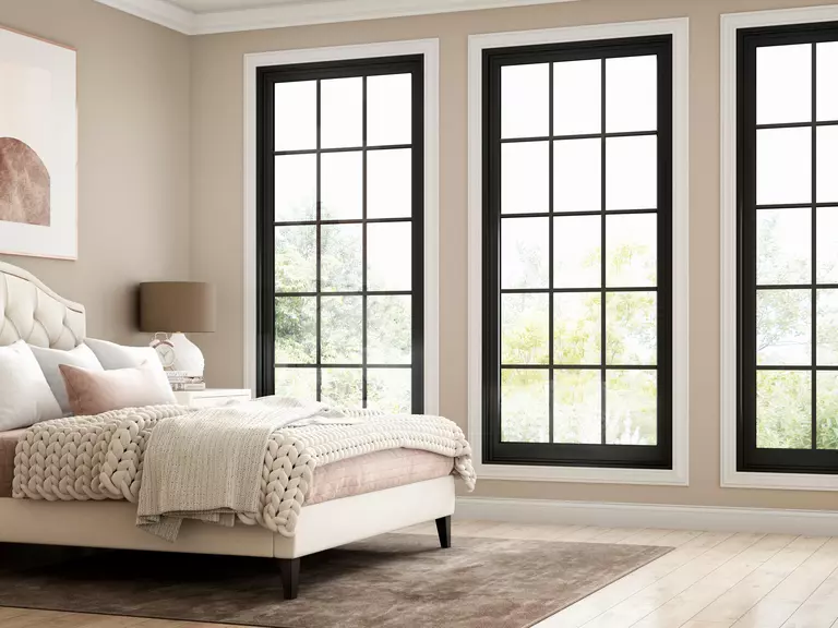 Bedroom with light coming in through energy-efficient windows, which are marked by a good U-value.