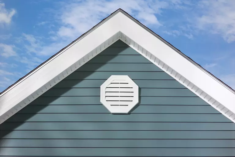 An up-close view of ocean blue vinyl siding on a home.