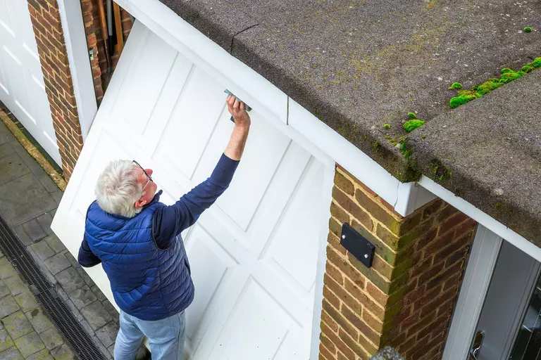 Man manually lifting a garage door.
