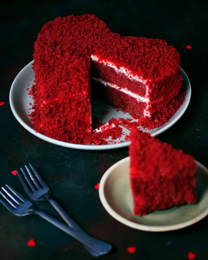 Heart-shaped red velvet cake on a plate