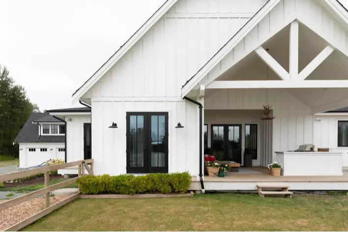 Front view of a farmhouse-style home with a large front porch