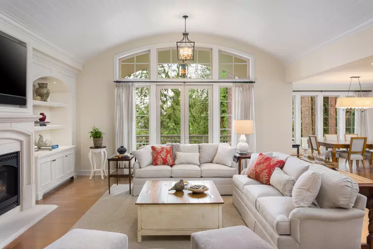 Living room wall with floor-to-ceiling combination of patio doors, picture windows, and architectural shape windows.