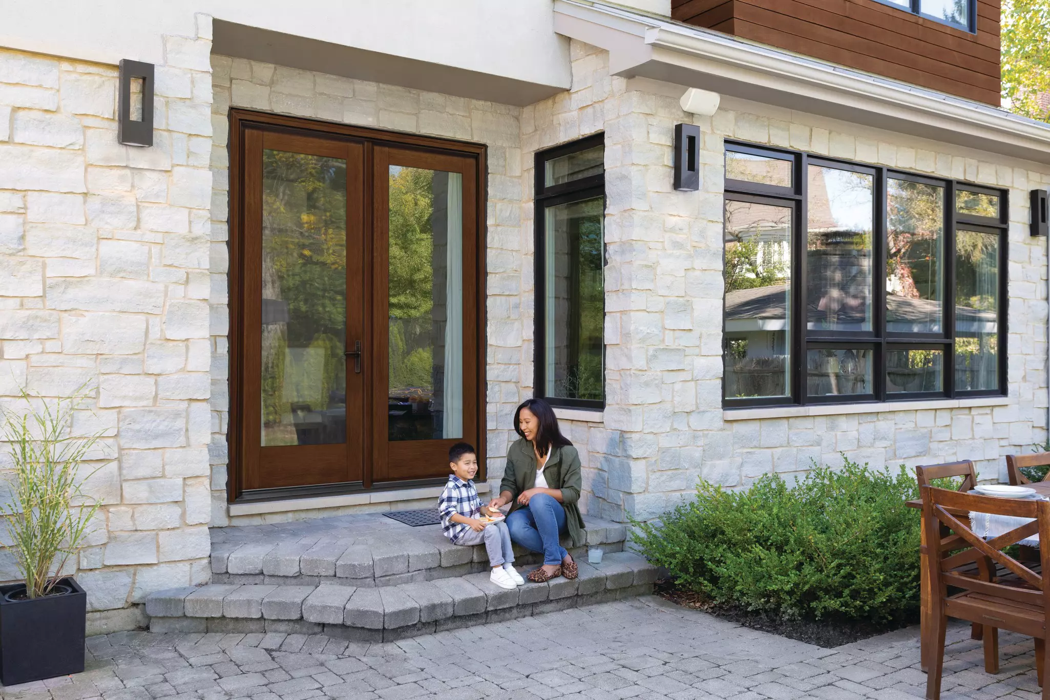Mother and child on the patio steps of a home.