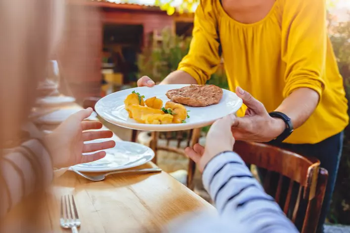 Woman carrying plate of food