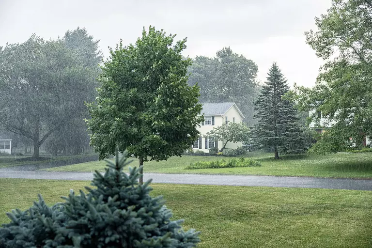 Suburban neighborhood experiencing heavy rainfall.