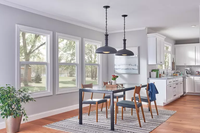Home dining room with three large double-hung windows.