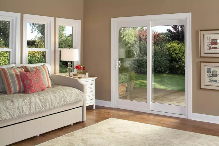Sliding glass door with a view of a stone patio outside.