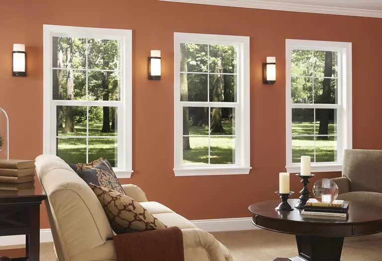 Living room with orange walls and energy-efficient windows.