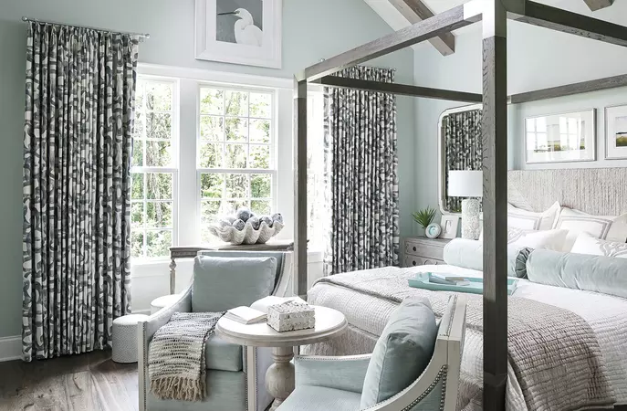 White wood-clad double-hung windows in a bedroom