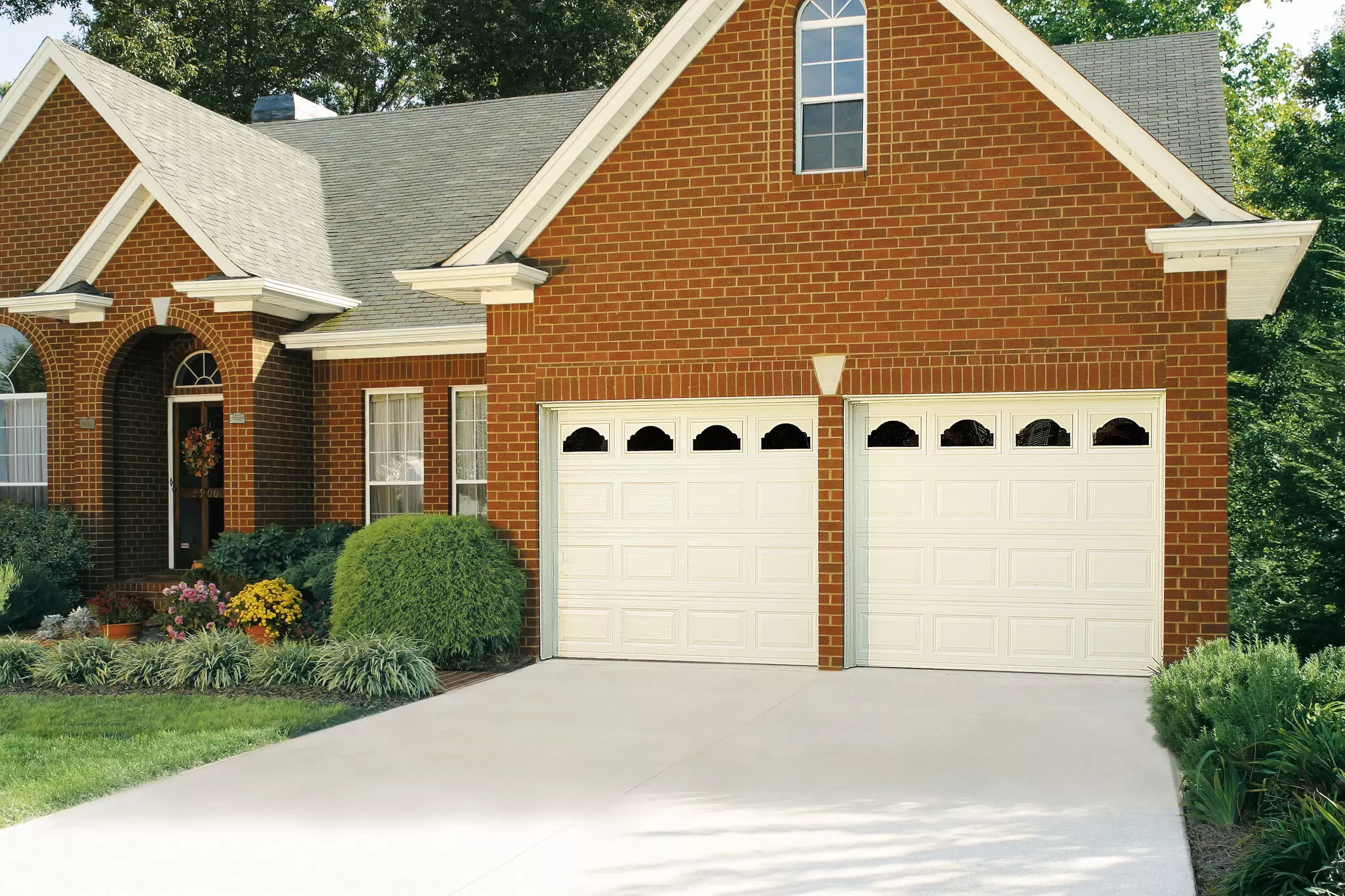 Driveway outside a home with two garage doors.