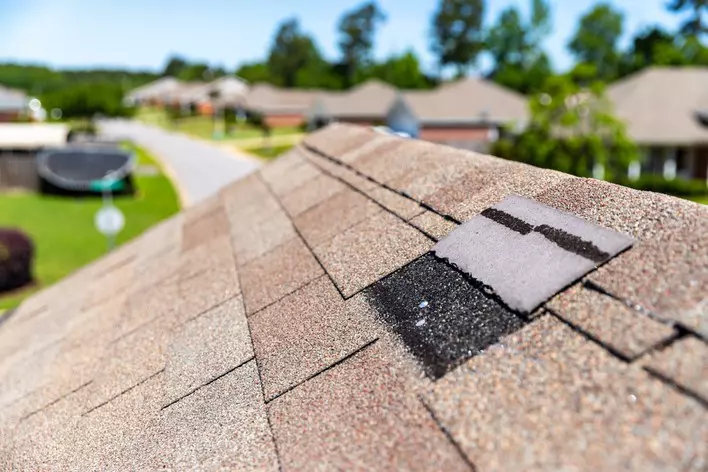 Brown roof with one shingle removed