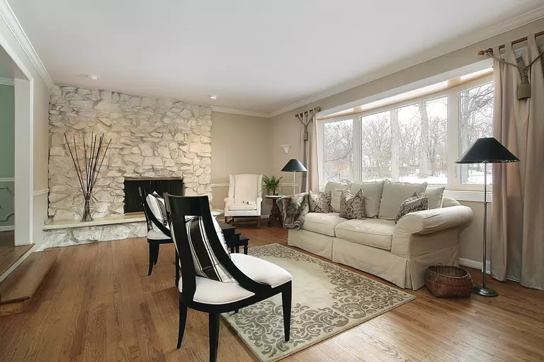 Living room with double-pane glass windows, meaning that heat will have a harder time transferring through these good R-value windows.