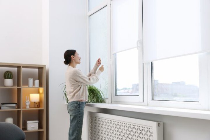 Woman adjusts blinds