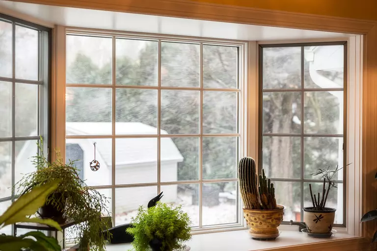 Large windows in the living room of a home with strong window frames to keep heat in
during cold months.